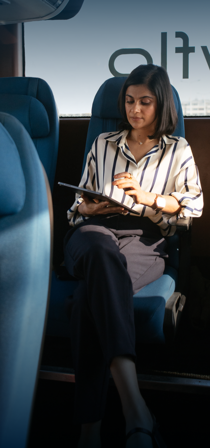 A Cityflo corporate bus with working professionals in Mumbai, on their way to Worli.