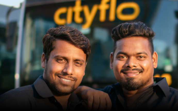 Our two professional bus drivers standing in front of a Cityflo bus for rentals from Maharashtra to Lonavala.